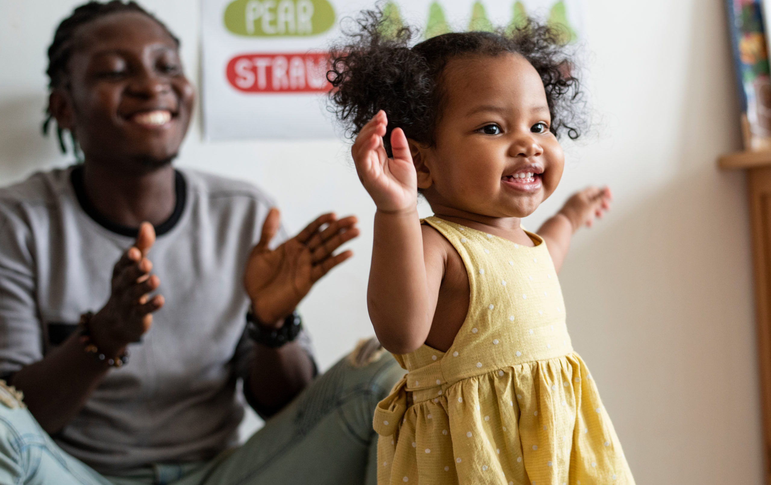 Toddler in yellow dress dancing during preschool programs at Premier Learning Center.